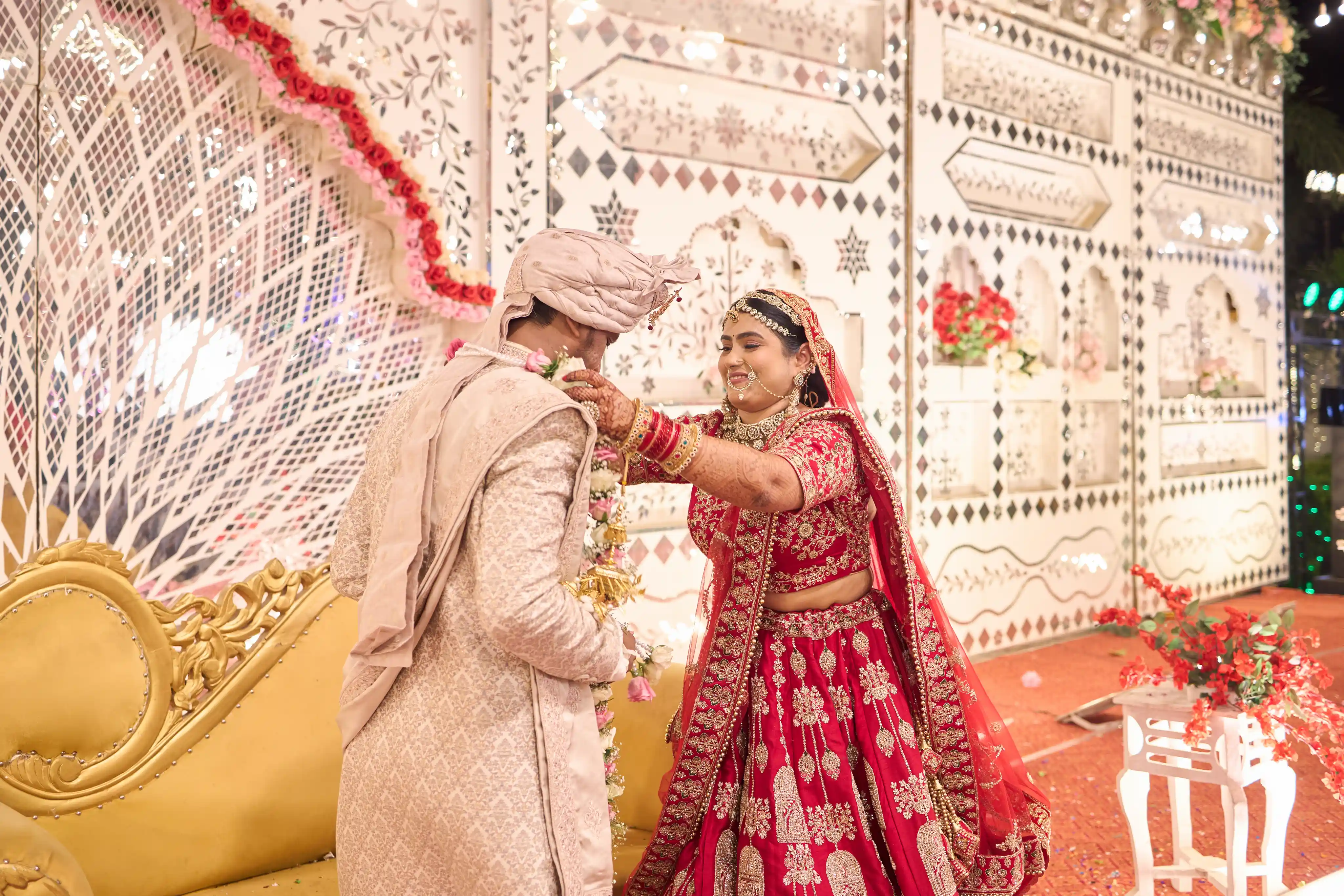 Bride placing the jaimala garland on the groom at R R Palace Marriage Lawn Varanasi wedding by The WeddingShoot